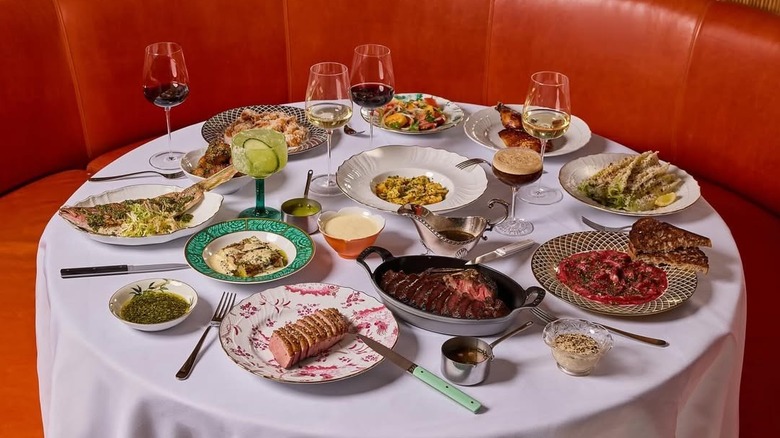 Full dining table with various plated dishes at Sunny's, Miami