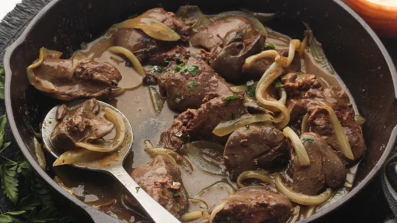 Iron pan of liver and onions with a spoon