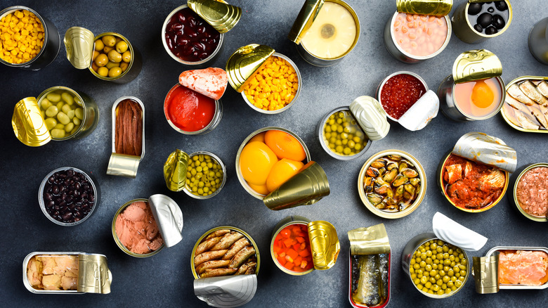 A variety of canned foods open on a countertop