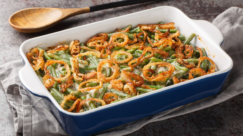Green bean casserole with crispy onions in baking dish