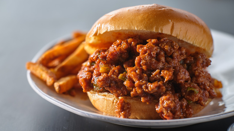 Sloppy joes burger on plate with sweet potato fries
