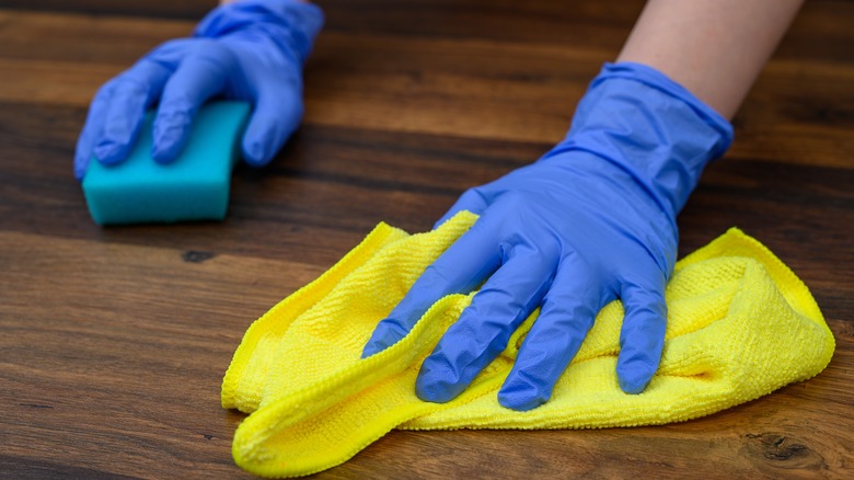 Person cleaning parquet flooring