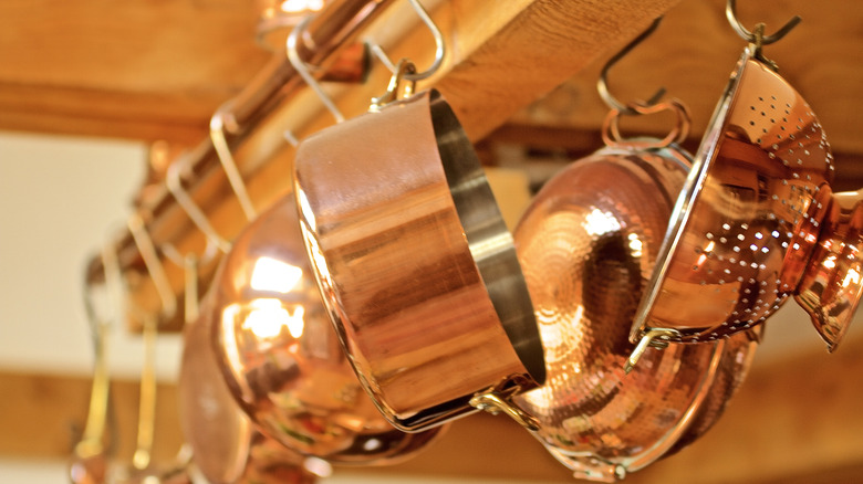 Copper pots hanging in a row