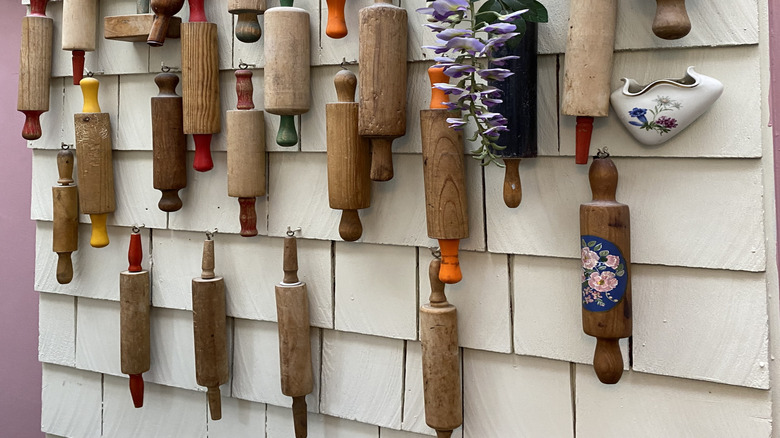 Art Deco rolling pins hung on a wall