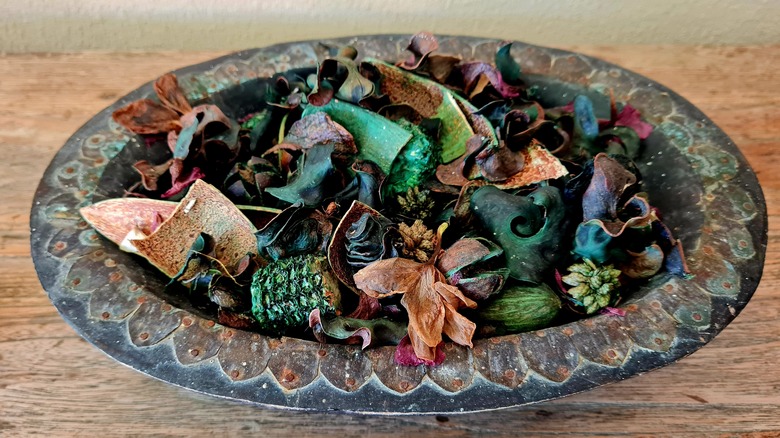 A bowl of potpourri placed on a wooden table