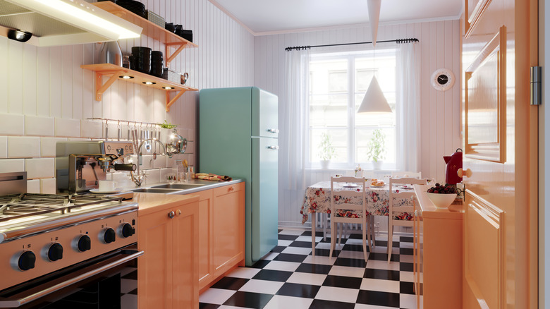 Vintage kitchen design with retro refrigerator, checkerboard flooring and a dining nook