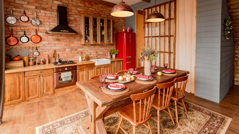 Cozy interior of a country-style kitchen with brick walls and wooden cabinets