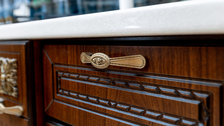 Brass drawer handle on wooden cabinets