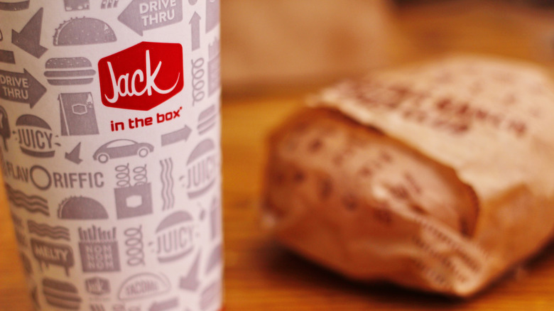 Drink from Jack in the Box with a burger blurred in the background