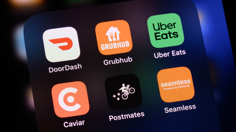 Cell phone showing various food delivery app icons