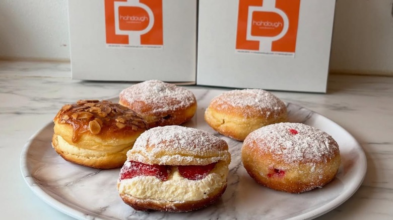 Fiver Berliner of various flavors on plate in front of Hahdough boxes