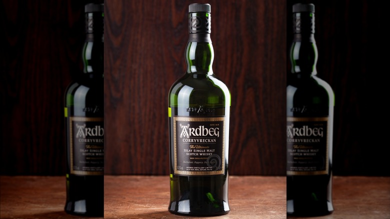 A close-up of a bottle of Ardbeg Corryvreckan showing the label against a plain wooden background