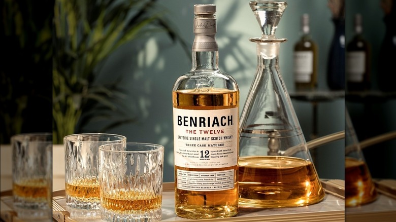 Benriach The Smoky 12 shown on a serving tray alongside a decanter and filled whisky glasses