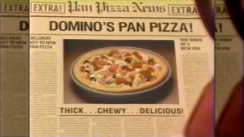 Commercial still Noid reading a newspaper with Domino's pizza featured image