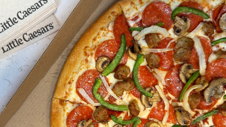 A Little Caesar's supreme pizza in a takeout box