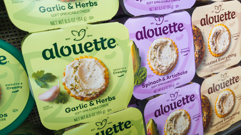 Alouette Cheese Varieties Displayed On Grocery Store Shelf