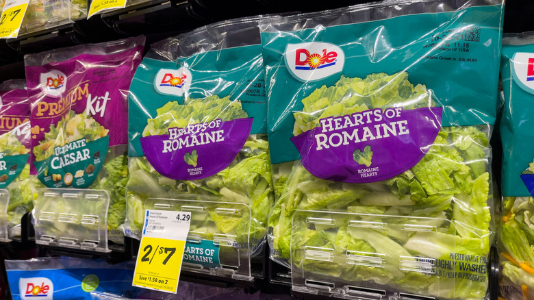 Dole bagged romaine salad lettuce on display at a grocery store