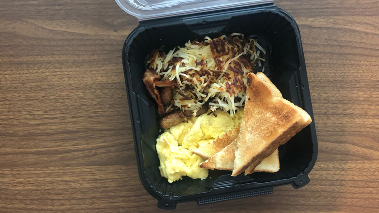 Denny's All-American Slam breakfast in to-go box.