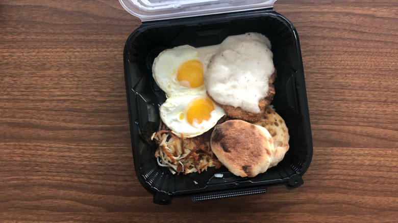 Denny's country fried steak and eggs in a to-go box.