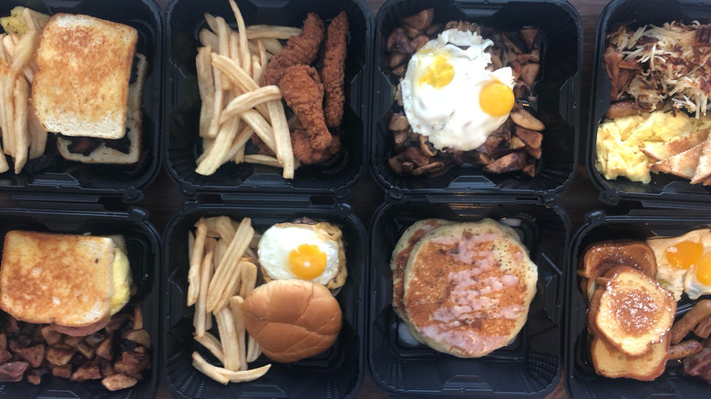 10 different Denny's menu items in to-go boxes.