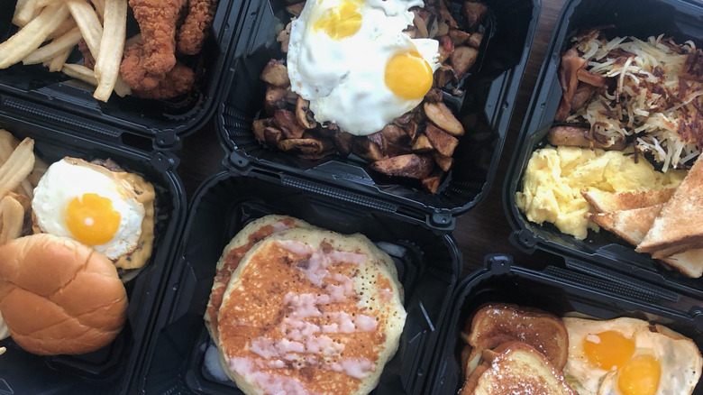 Denny's meals in to-go boxes.