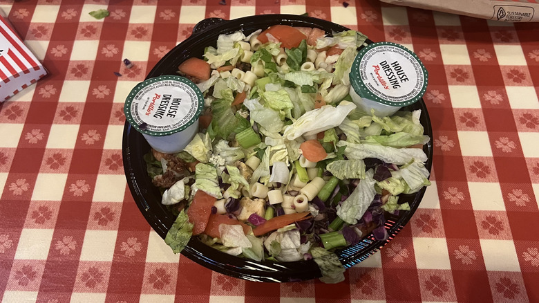 Portillo's chopped salad with cups of dressing.