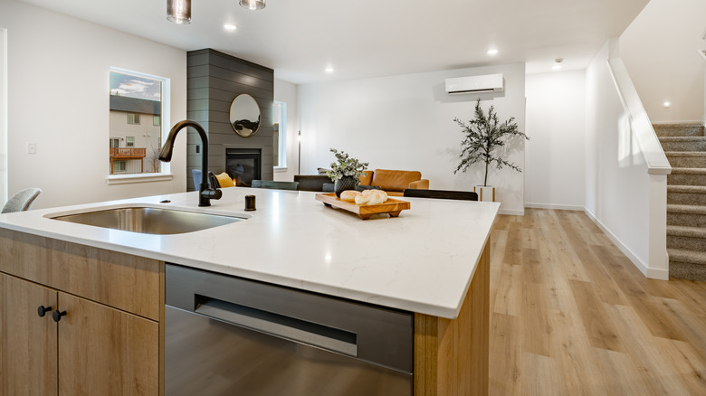 Modern kitchen interior with wooden flooring and cabinets