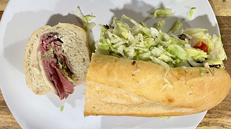 Cross section cut of roast beef sub sandwich on a plate