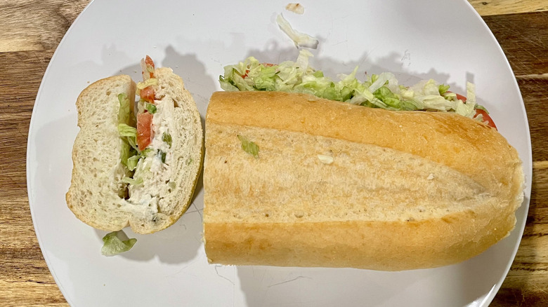 Cross section cut of a chicken salad sub sandwich on a plate