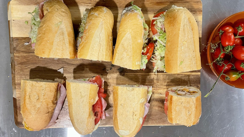An assortment of Publix sub sandwiches on a cutting board