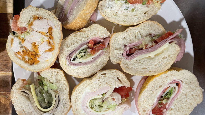 Numerous different sub sandwich slices displayed on a plate