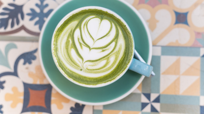 Top view of matcha latte on patterned background