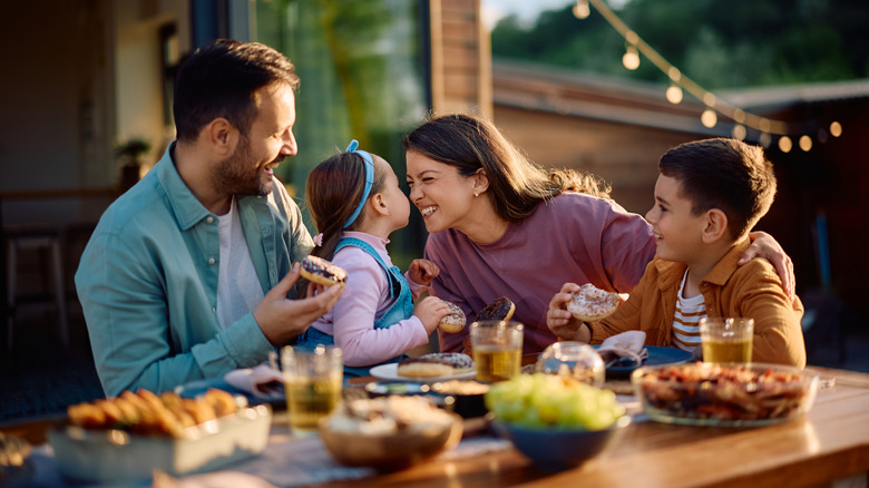 Family enjoying a meat together outside