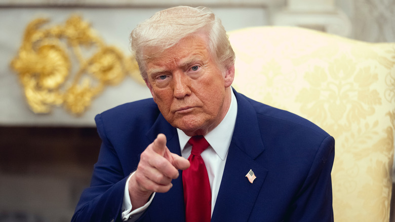 President Trump pointing sitting in a chair