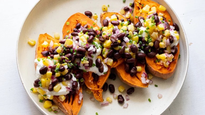Loaded sweet potatoes on white plate