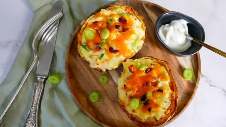Overhead view of twice-baked potatoes with toppings