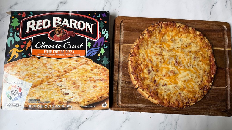 Red Baron Classic Crust Four Cheese pizza box next to pizza on cutting board