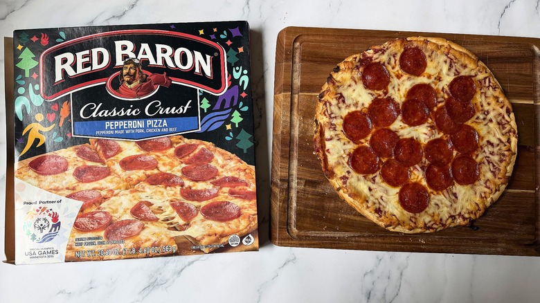Red Baron Classic Crust Pepperoni pizza box next to pizza on cutting board