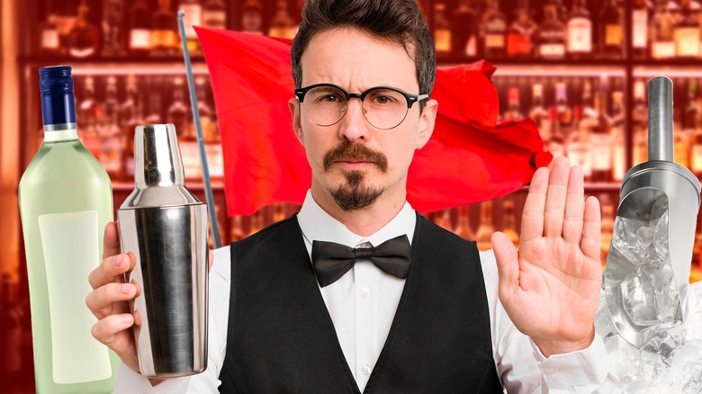 bartender holding shaker at bar and red flag