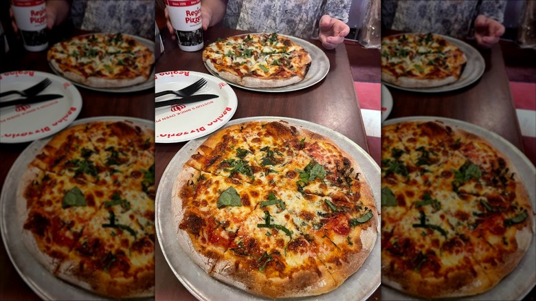 two pizzas on a restaurant table at Regina Pizzeria