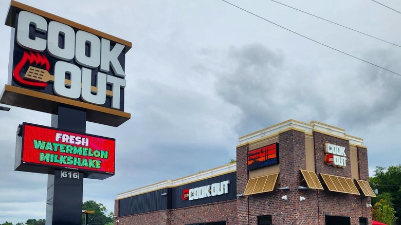 Exterior of Cook Out restaurant with big sign in foreground