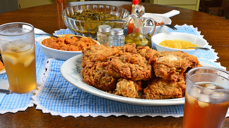 Dishes of fried chicken and other classic Southern soul food on a table
