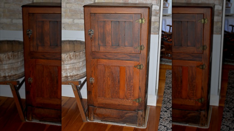 Large wooden vintage icebox in kitchen