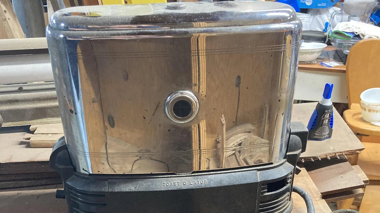Silver vintage Toast-o-lator in cluttered room