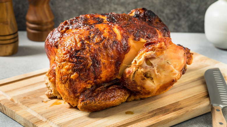 Dry rotisserie chicken on wooden cutting board