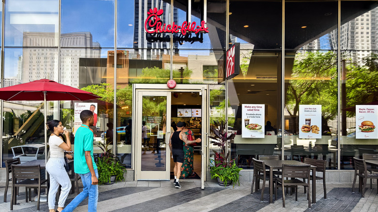 Chick-fil-A storefront with people walking by