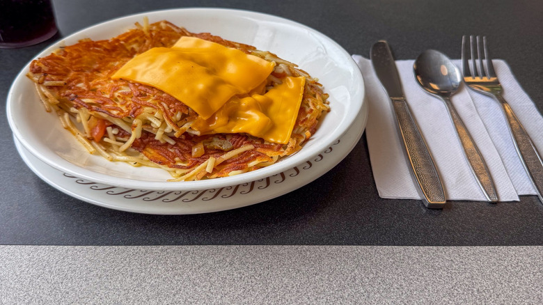 Waffle House hash browns topped with slices of cheese