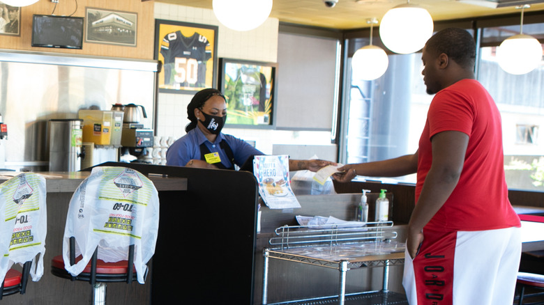 Customer paying at the register in a Waffle House
