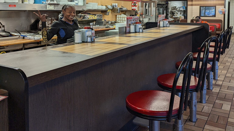 Worker behind the counter at Waffle House
