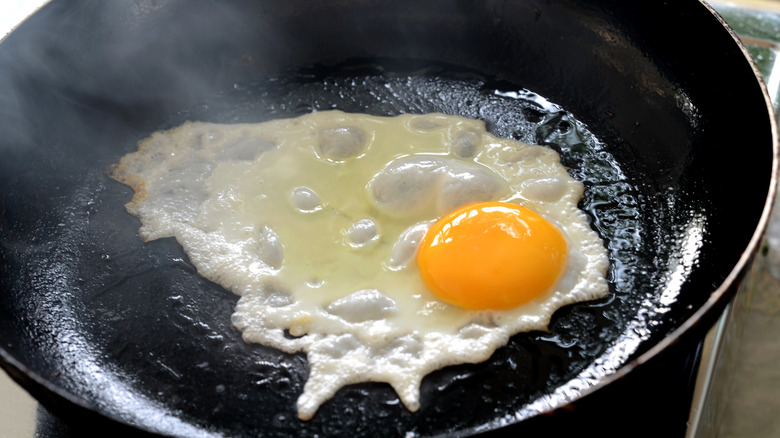 fried egg in a black pan